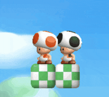 two toads are standing on top of a checkered block