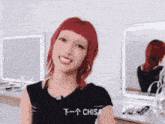 a woman with red hair is wearing a black shirt that says chisa on it