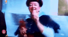 a woman in a hat is dancing on a television screen with the number 4 in the corner