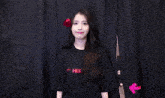 a woman wearing a black t-shirt that says i love her
