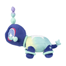a purple and green stuffed animal with a diamond in its eye