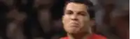 a close up of a man 's face in a red shirt .