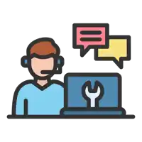 a man wearing a headset sits in front of a laptop with a wrench on it