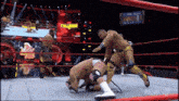two men are wrestling in a ring with a sign above them that says collision