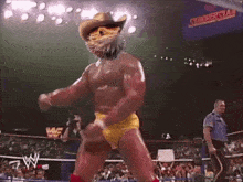 a wrestler is wearing a cowboy hat and yellow underwear in a wrestling ring .