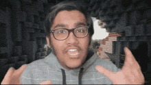 a man with glasses and a beard is making a funny face in front of a minecraft background .