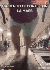 a woman is walking on a treadmill in a gym .
