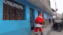 a man dressed as santa claus walking down a street