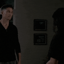 a man in a black shirt is dancing with a woman .