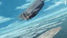 a kaiju no 8 poster shows a person falling into the ocean