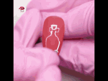 a red nail with a white bottle on it