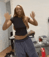 a woman is dancing in a living room in front of a piano .