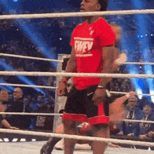 a wrestler in a red shirt that says fwev on it