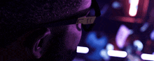 a man wearing a pair of sunglasses with the letter t on it