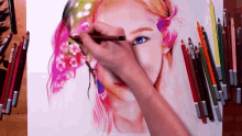 a person is drawing a woman 's face with colored pencils and one of the pencils has the word prismacolor on it