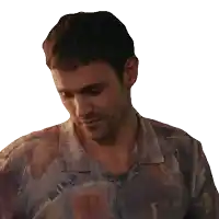 a man wearing a colorful shirt looks down