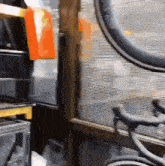 a bicycle wheel is sitting in front of a window in a room