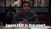 a man sits at a desk with a book and says " i want tbd is that new "