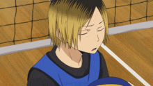 a volleyball player with his eyes closed holds a ball
