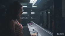 a woman is looking at herself in a mirror with netflix written on the bottom