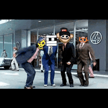 a group of men in suits and masks are dancing in front of a building with a number 4 on it