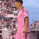 a man wearing a pink jersey with the number 9 on the front