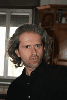 a man with gray hair making a funny face
