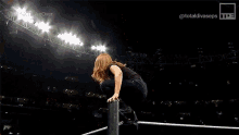 a blurry picture of two women fighting with the words nxt take over on the bottom right