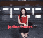 a woman in a red top and black shorts is dancing with the words jadina enters below her