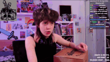 a girl is sitting in front of a box that says slime on it