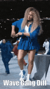 a woman in a blue outfit is dancing with the words wave gang diff on the bottom