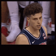 a basketball player wearing a blue jersey that says xii