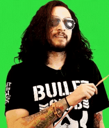 a man wearing sunglasses and a t-shirt that says bull on it