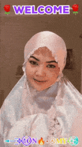 a woman wearing a hijab is smiling with the words welcome above her