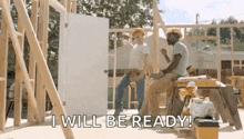 a couple of construction workers are sitting on a stool in front of a house under construction .