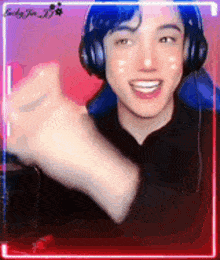 a young man wearing headphones is giving a thumbs up sign .