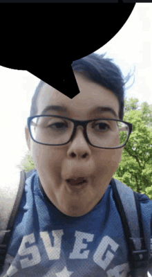 a boy wearing glasses and a blue shirt that says svegs