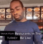 a man in a blue shirt is standing in front of a display of food and a sign that says turkey be like