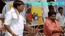 a man in a white shirt is standing next to a woman in a red shirt in front of a sign that says starttamilchat in