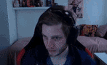 a man wearing headphones is sitting in a chair in front of a computer .