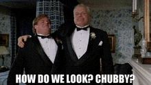 two men in tuxedos are standing next to each other and one of them is asking how do we look ? chubby ?