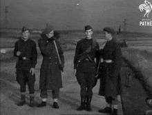 a black and white photo of a group of soldiers with the pathe logo in the corner