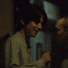 a man and a woman are standing next to each other and looking at each other .
