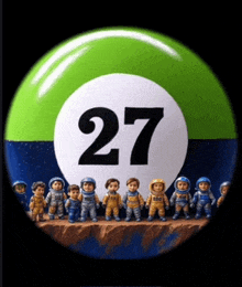 a group of astronauts standing in front of a ball with the number 27