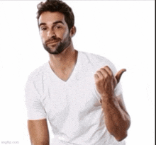a man with a beard wearing a white t-shirt is giving a thumbs up .