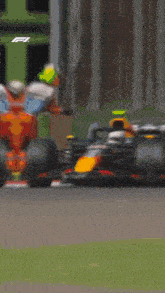 a close up of a race car with a green sign behind it that says ' a '