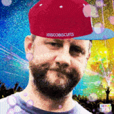 a man wearing a red hat that says discobiscuits on it