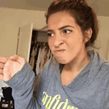 a woman wearing a hoodie that says ' confidence ' on it