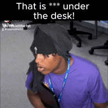 a man in a purple shirt with a lanyard that says state