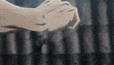 a close up of a person 's fist with a feather stuck in it